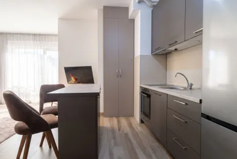 Modern kitchen with dark cabinets and a dining island. - image 4