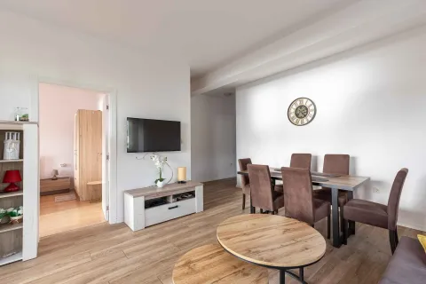 Living room with a dining table and chairs. - image 2