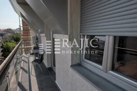 Balcony with a table and chairs and a city view. - image 17