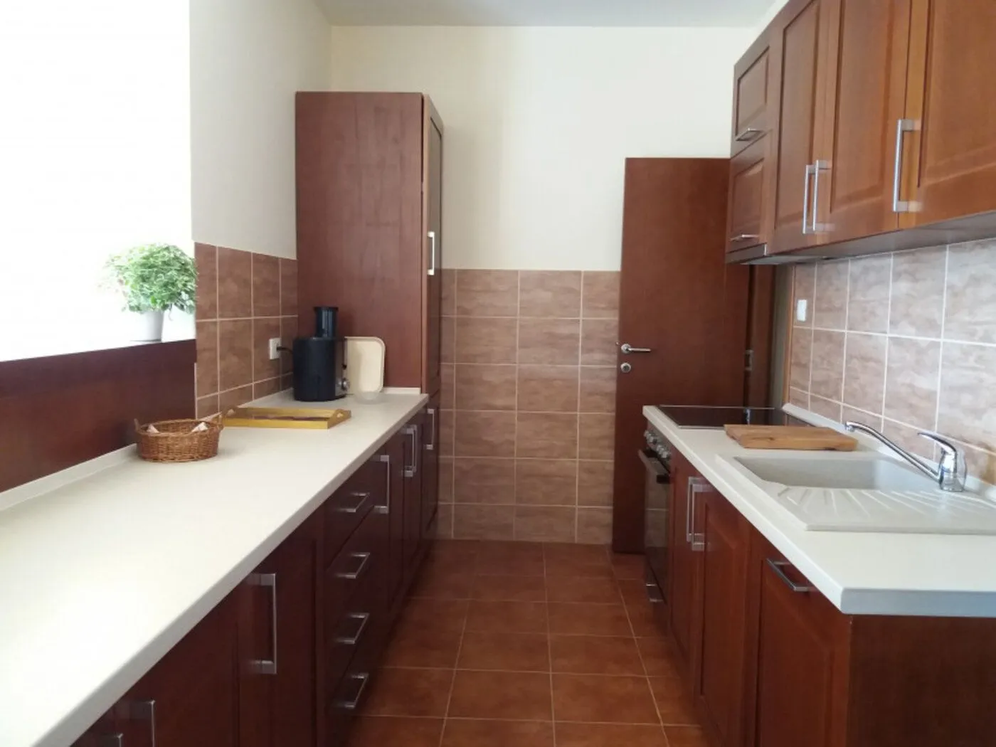 Spacious kitchen with wooden cabinets and countertops.