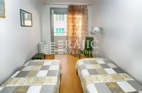 Bedroom with two single beds and balcony access. - image 2