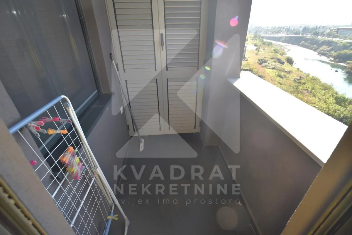 Small balcony with a drying rack and a river view.