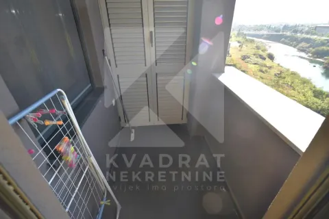 Small balcony with a drying rack and a river view. - image 10
