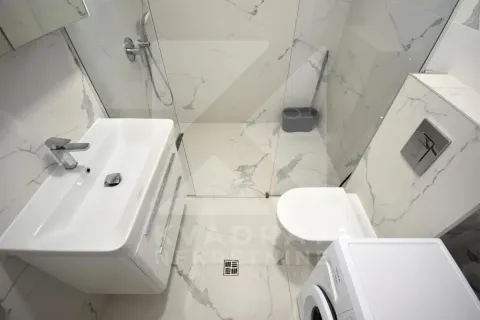 Modern bathroom with a walk-in shower, washbasin, and marble-tiled fixtures. - image 14
