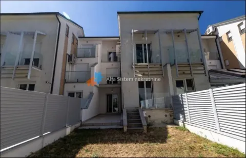 Rear view of the building with a yard and balconies. - image 13