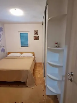 Smaller bedroom with a double bed and a built-in wardrobe. - image 9