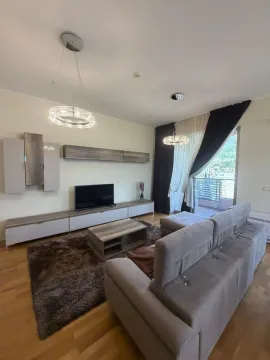 Living room with sofa, TV unit, and terrace access. - image 3