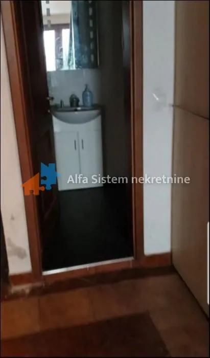 View from the hallway into the bathroom with a sink.
