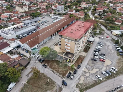 Aerial view of the residential building and surrounding area with parking. - image 2