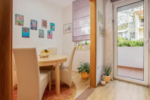 Dining area with a table, chairs, and access to the terrace. - image 8