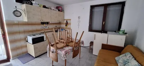 Small kitchen with a dining table and sofa. - image 12