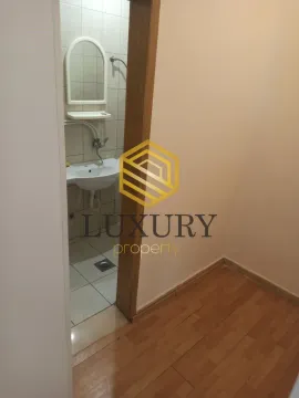 View from the hallway into the bathroom with a sink and mirror. - image 8