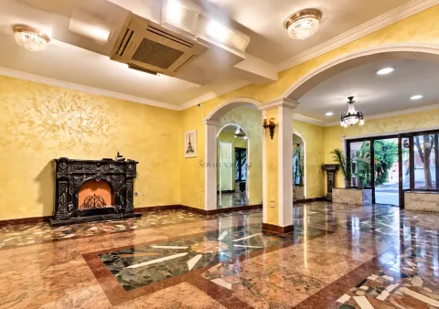 Spacious living room with a fireplace and marble floor. - image 3