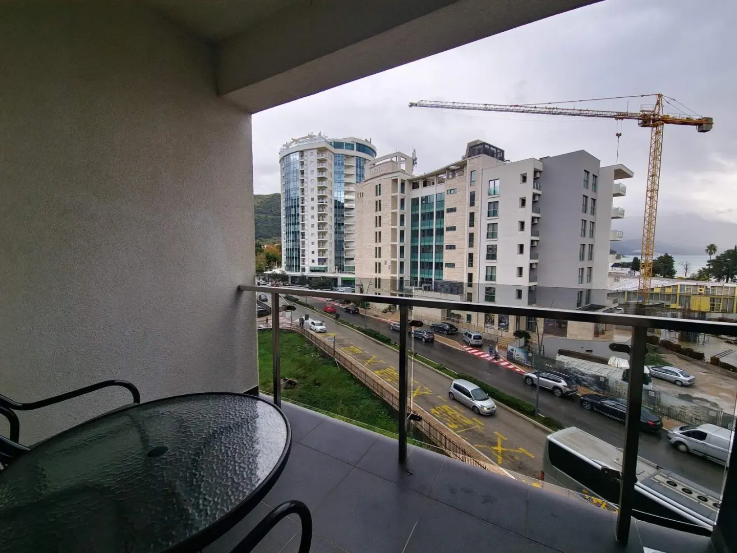 View from the balcony overlooking the city street and surrounding buildings.