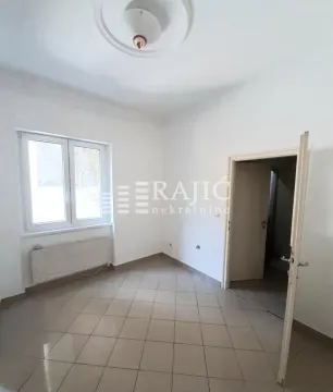 Empty room with tiled flooring and a window. - image 5
