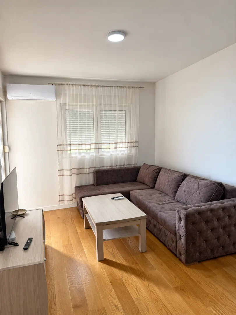 Living room with a sectional sofa, coffee table and television.