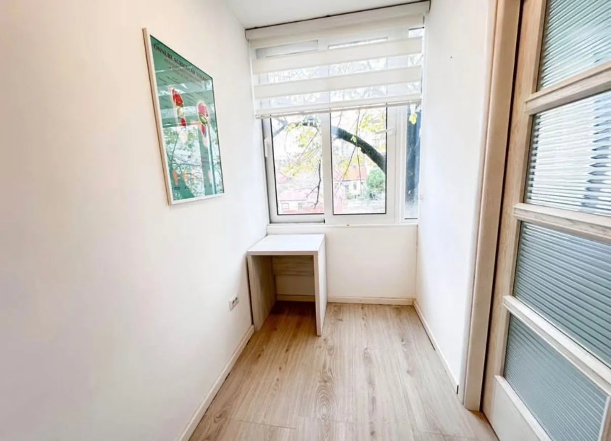 Small room with a desk and window.
