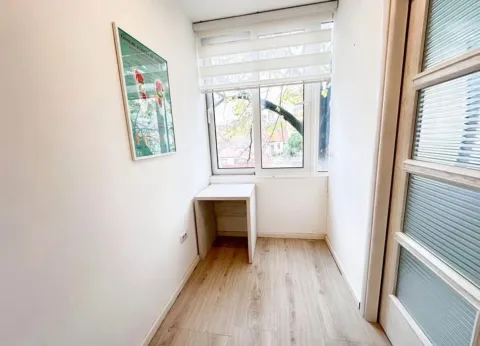 Small room with a desk and window. - image 5