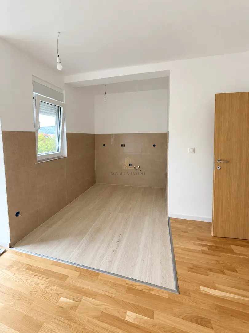 Unfurnished kitchen area with ceramic tiles and a window.