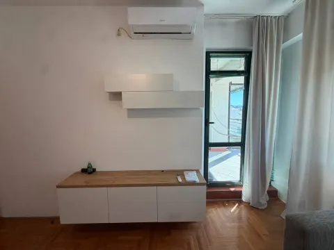 Living room with parquet flooring, white furniture, and an air conditioning unit. - image 3