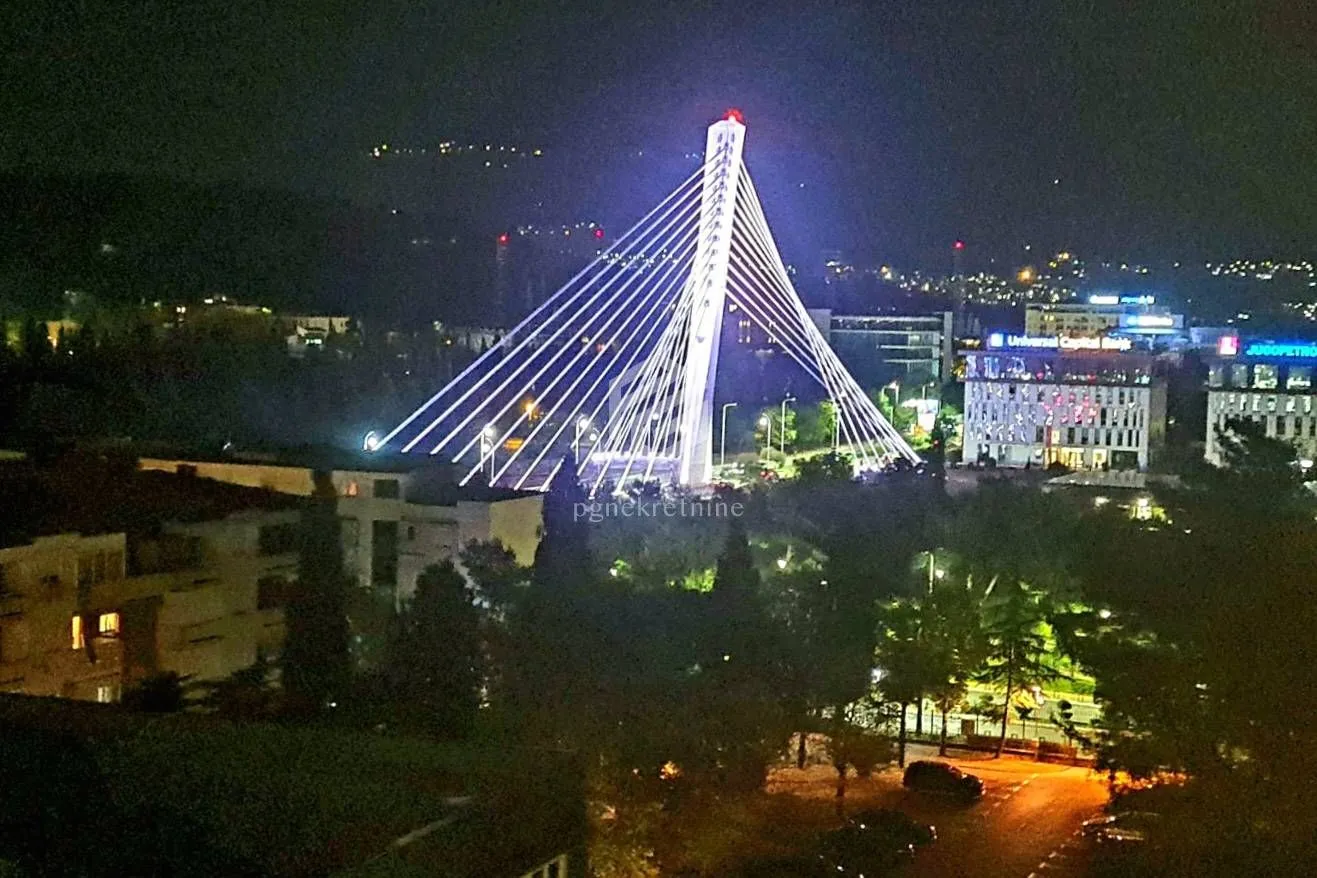 Night view from the window of the illuminated bridge and city.