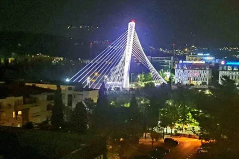 Night view from the window of the illuminated bridge and city. - image 7