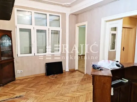 Empty room with parquet flooring and large windows. - image 9