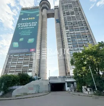 Exterior view of a tall residential and commercial building with an entrance drive. - image 11