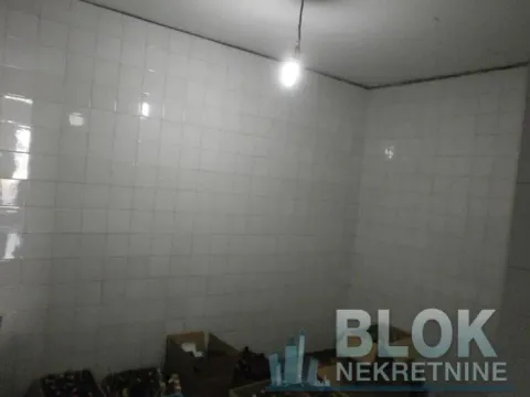 Small room with white wall tiles and boxes on the floor. - image 4
