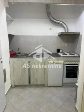 Small kitchen with wood-patterned cabinets and built-in appliances. - image 8