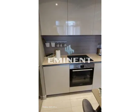 Part of the kitchen with a built-in oven and light-toned cabinets. - image 6