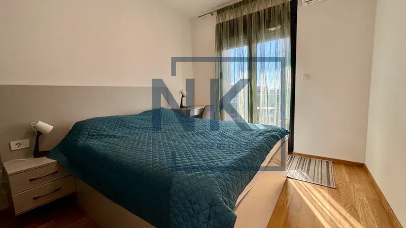 Furnished bedroom with a double bed, bedside table, and access to the terrace.
