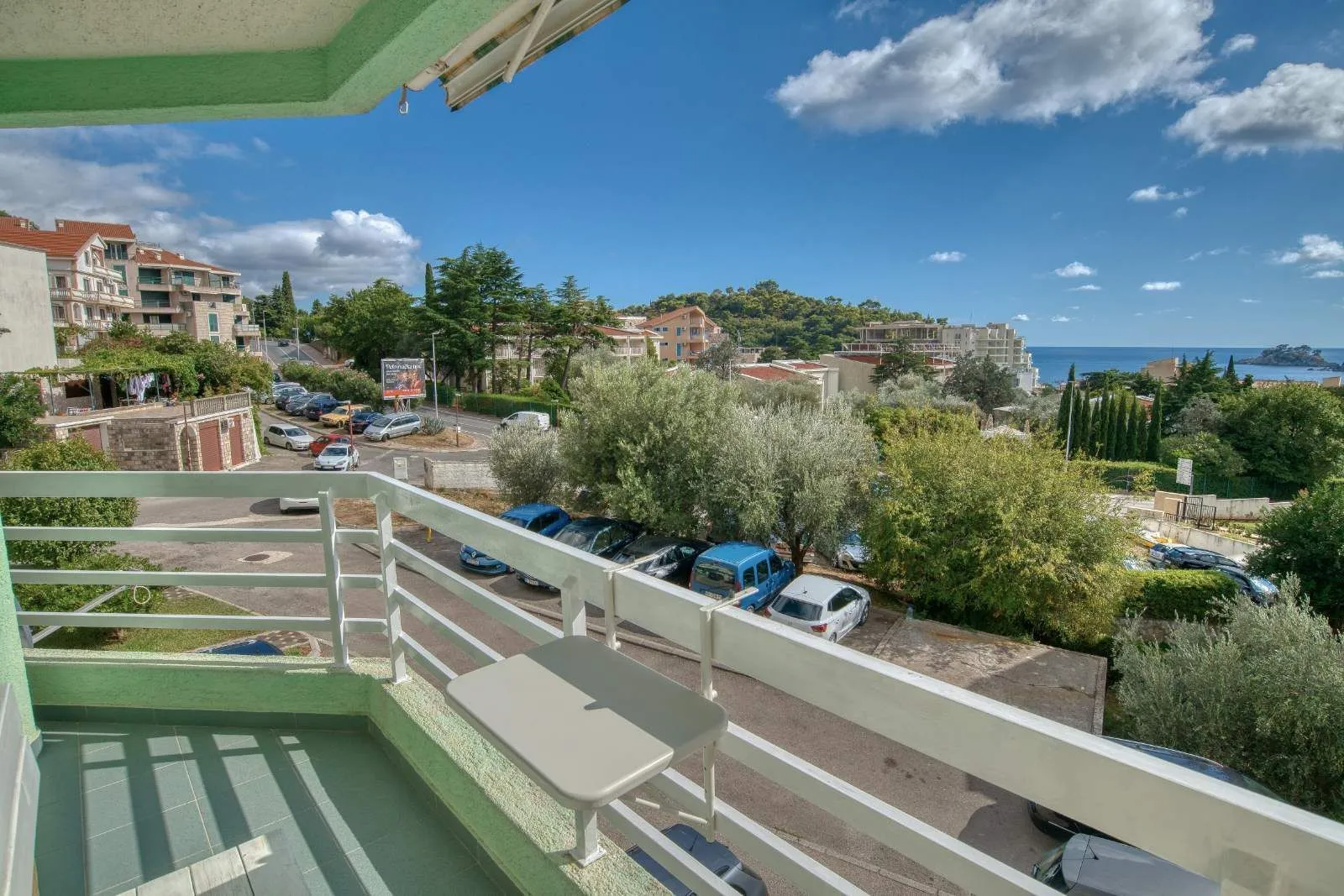 View from the balcony overlooking the neighborhood and surrounding greenery.