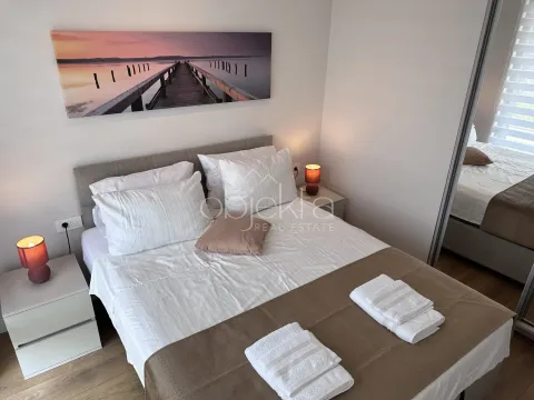 Bedroom with a double bed, bedside tables, and a wall picture. - image 10