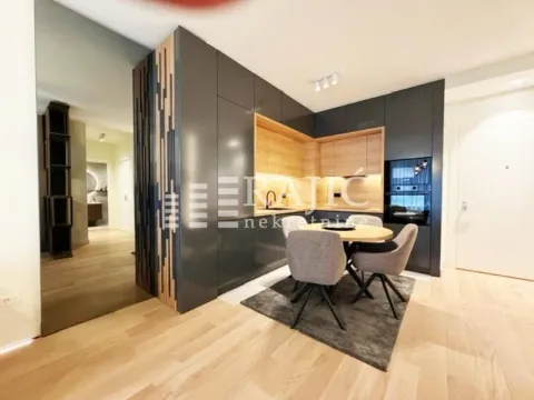 Modern kitchen with a dining table and chairs in an open space. - image 3