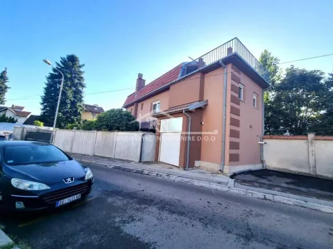 View of the exterior of the house with a courtyard and street in the foreground. - image 2