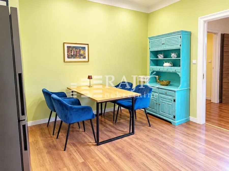 Dining room with a dining table, blue chairs, and a turquoise cabinet.