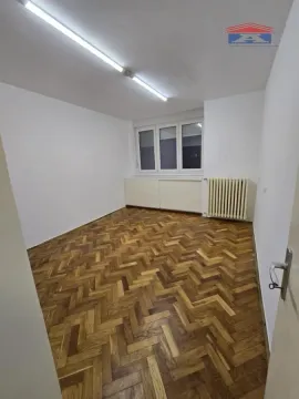 Empty room with parquet flooring and white walls. - image 5