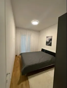 Bedroom with a double bed, white walls and balcony doors. - image 5