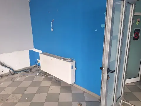 Empty room with floor tiles, a blue wall, and an air conditioning unit. - image 5