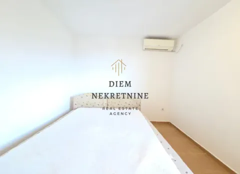 Bedroom with a bed and an air conditioner. - image 7