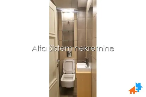 Smaller bathroom with a wall-hung toilet and washbasin. - image 16
