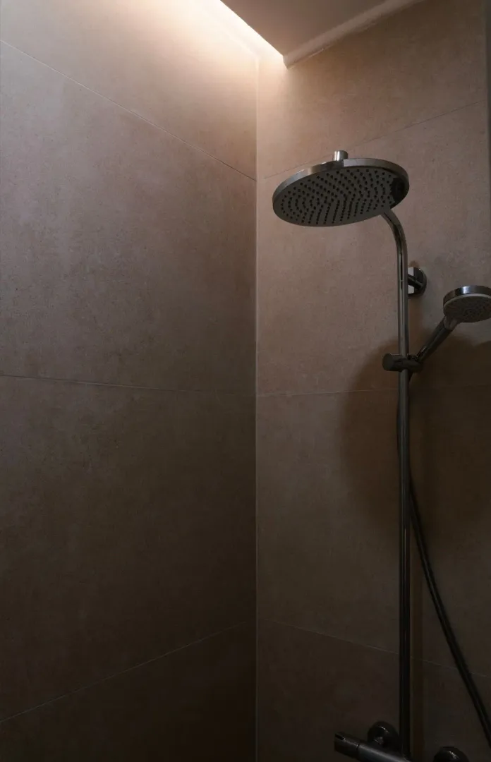 Modern shower system in a tiled bathroom.