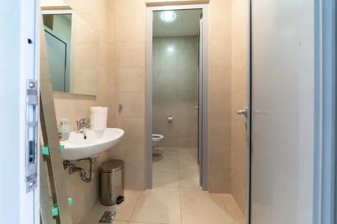Smaller bathroom with a washbasin and wall tiles. - image 8