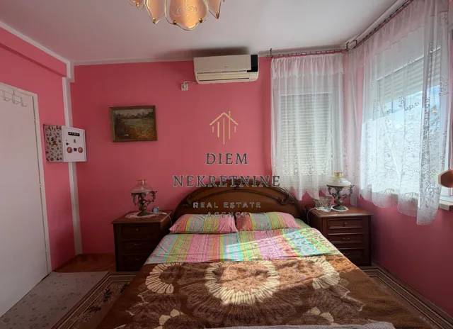 Bedroom with a double bed and pink walls.