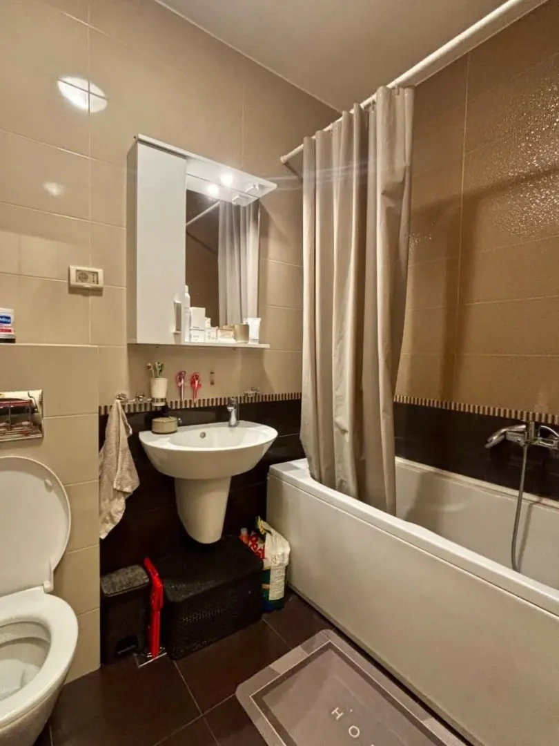 Small bathroom with a bathtub, sink, and toilet.