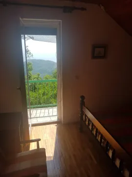 Bedroom with a bed and access to a terrace with a nature view. - image 8