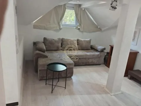 Living room with a sectional sofa and a small coffee table in the attic. - image 5