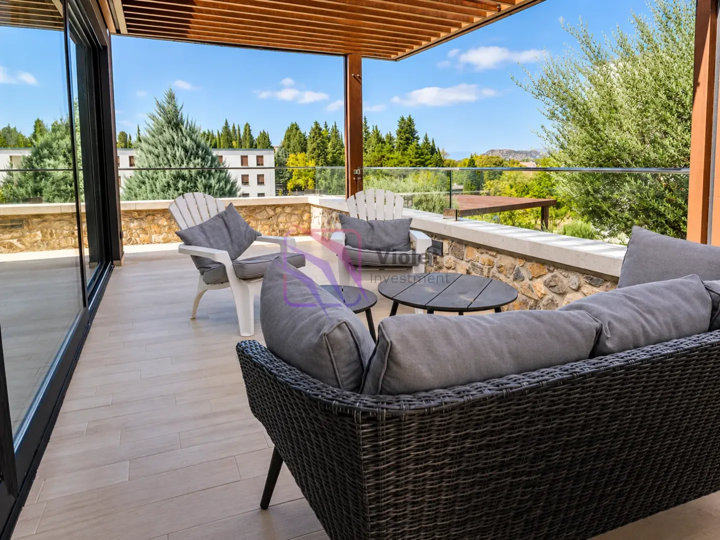 Spacious terrace with outdoor seating and a natural view.