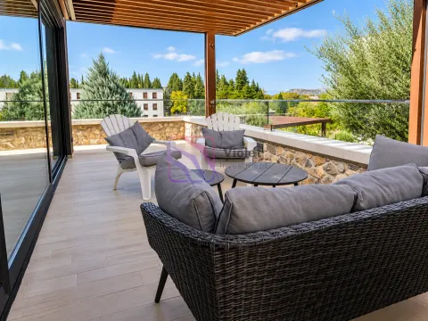 Spacious terrace with outdoor seating and a natural view. - image 16
